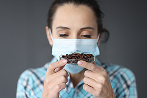 woman smelling coffee grounds